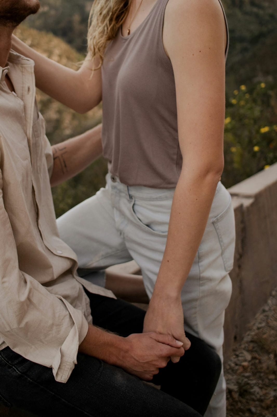 A couple sitting holding hands